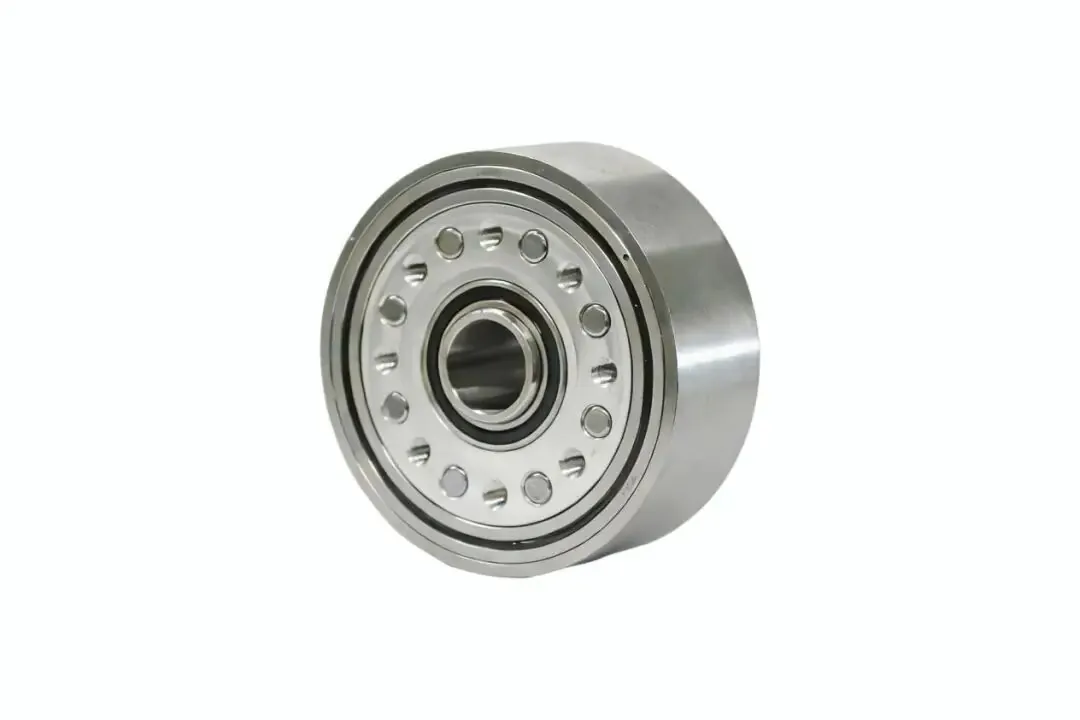 A shiny, cylindrical mechanical component featuring a central bearing assembly surrounded by evenly spaced circular indentations on a metallic face.