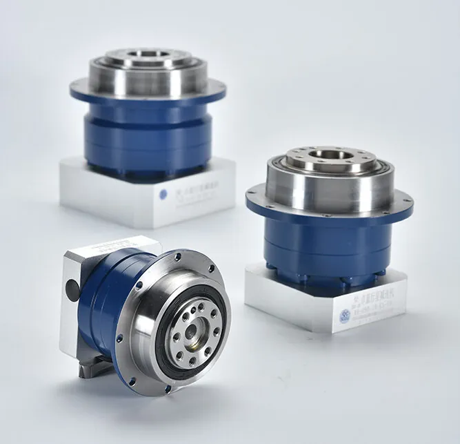 Three blue and silver planetary gearboxes are arranged on a white surface. The top gearbox is angled, while the two below are parallel.