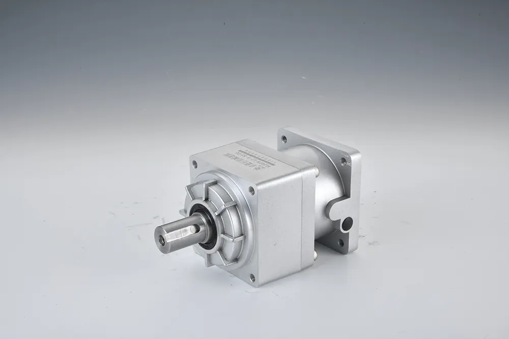 A silver planetary gearbox, model VLF078-L1-5-S2-P2, with a keyed output shaft, lying on its side on a white surface.