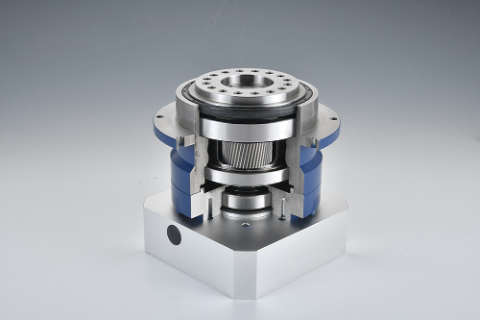 A cutaway view of a precision gearbox with blue housing, showing internal gears and bearings, mounted on a silver base.