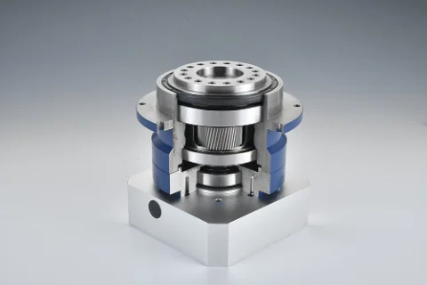 A cutaway view of a precision gearbox with blue housing, showing internal gears and bearings, mounted on a silver base.